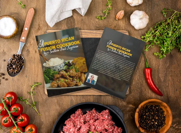 A Puerto Rican Fusion Cookbook on the kitchen table with fresh ingredients