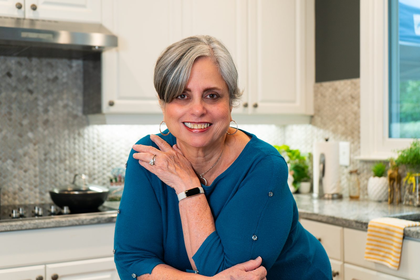 Cecie Andaluz-Hammett smiling in her kitchen