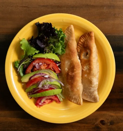 Empanadillas on a yellow plate, from the cookbook