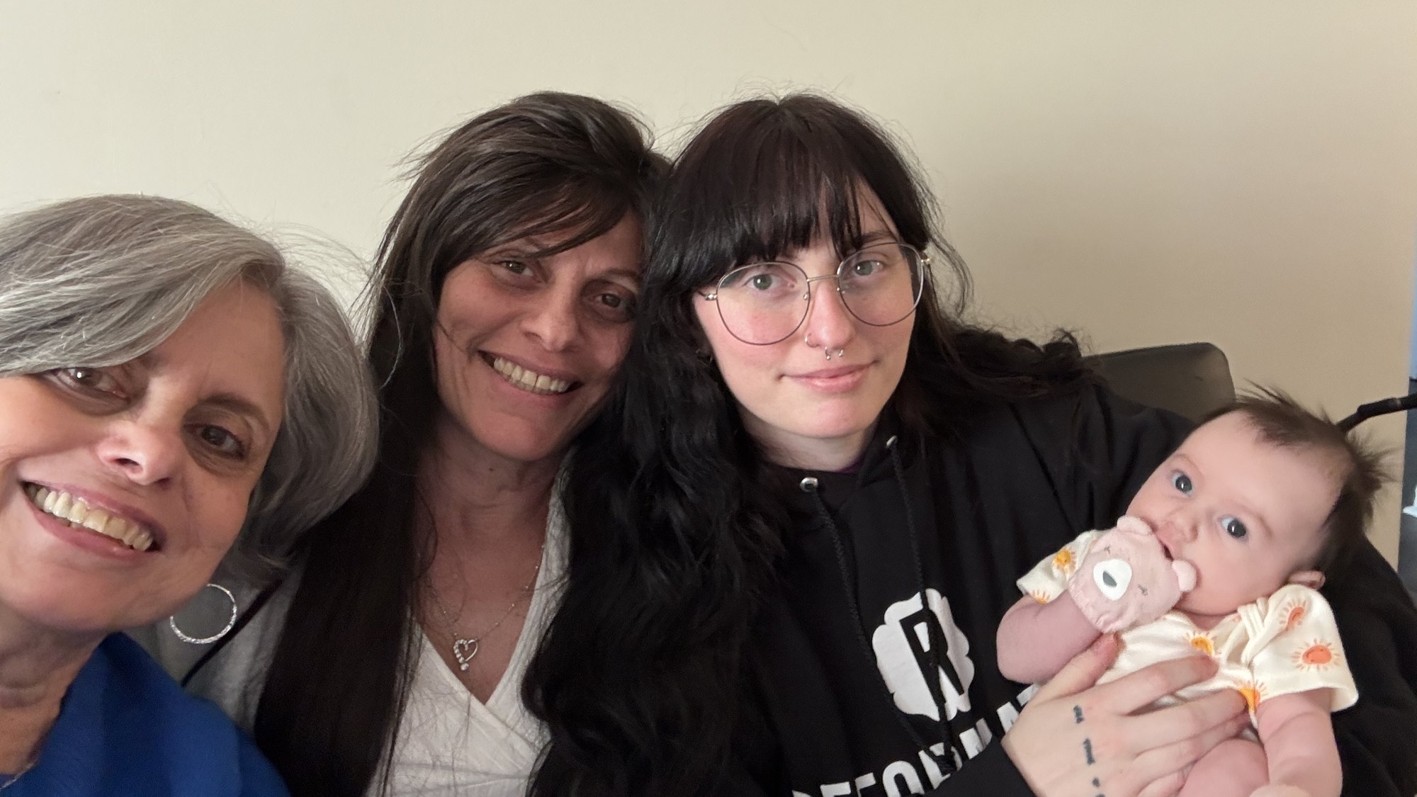 Four generations of Cecie's family together — Cecie at left, the youngest in arms at right
