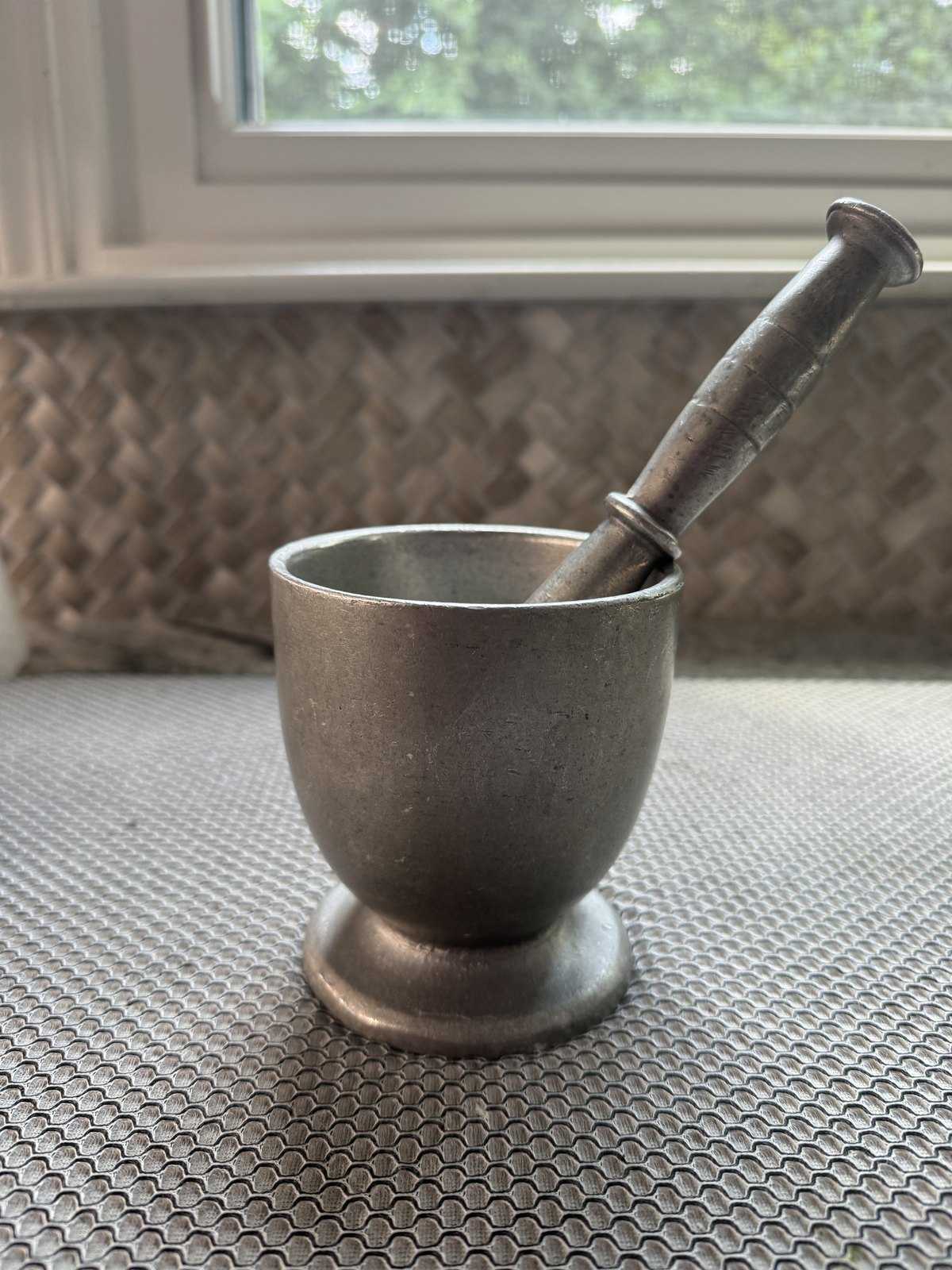 The aluminum pilón — mortar and pestle — Mami left to Cecie